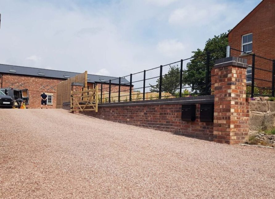 Large gravel driveway stretching the length of a new build house